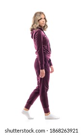 Side View Of Relaxed Calm Young Woman In Sweatshirt And Sweatpants Walking. Full Body Length Isolated On White Background. 