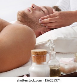 Side View Of Relaxed Man Getting Scalp Massage