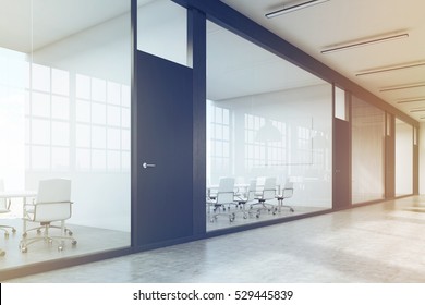 Side View Of A Row Of Meeting Rooms In A Long Corridor. Glass Walls, Black Doors. Concept Of Communication. 3d Rendering. Toned Image