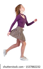 Side View Of Running Woman In Dress. Beautiful Redhead Girl In Motion. Back Side View Of Person. Rear View People Collection. Isolated Over White Background. A Girl In A Short Skirt Rushing Past.