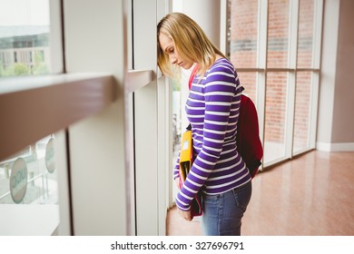 Side View Of Sad Female Student By Window In College