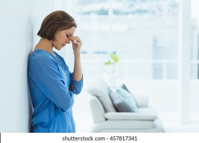 Side View Of Sad Woman Standing At Home