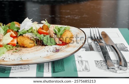 Side View of Salad with Tuna and Crispy Croquettes.