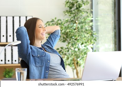 Side view of a satisfied entrepreneur with a new job looking through the window at office - Shutterstock ID 492576991