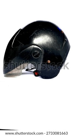 Side view of a scratched black open-face motorcycle helmet with a clear visor isolated on white background
