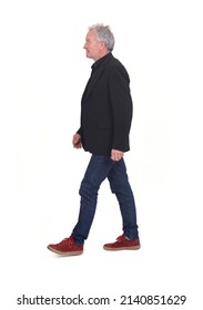 Side View Of Senior Man Walking On White Background