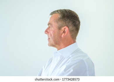 Side View Of An Serious Middle-aged Man With Deadpan Expression