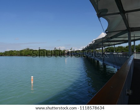 Side view of the shaded walkway at the floating dock of arvest Caye in Southern Belize.