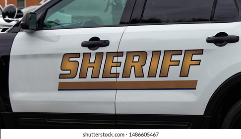 Side view of Sheriff's car door with SHERIFF text symbol.