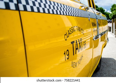 Side View Of A Shining Yellow Classic Taxi With Black And White Grid Displaying Ride Fare, New York, USA 