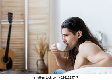 Side View Of Shirtless Man With Long Hair Drinking Coffee From Cup