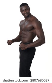 side view of Shirtless man posing and looking at camera on white background.