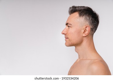 Side View Shot Of An Attractive Mature Naked Man Isolated Over White Background