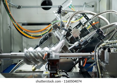 Side View Shot Of Complex Metal Mechanism On Assembly Line At Factory, Copy Space