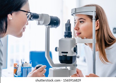 Side view shot of female doctor and patient in ophthalmology clinic