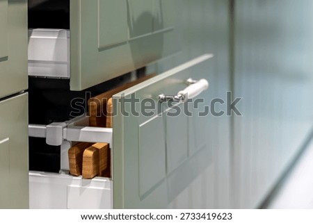 Side view shows a pullout drawer with wood boards and a white inner system. Declutter organization concept for modern kitchen and smart homedecor styling.