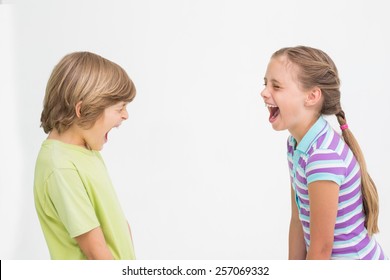 Side View Of Siblings Laughing On White Background