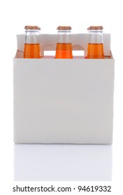 Side View Of A Six Pack Of Orange Soda Bottles Over A White Background With Reflection.