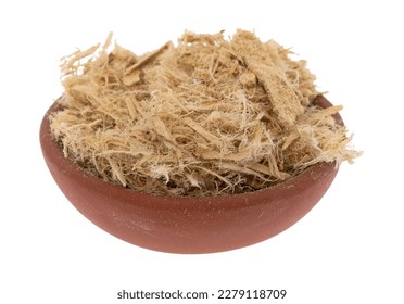Side view of a small bowl filled with shredded slippery elm bark on a white background.