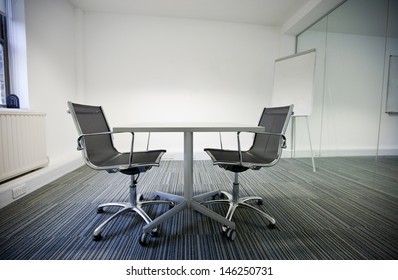 Side View Of Small Table And Two Chairs In Office