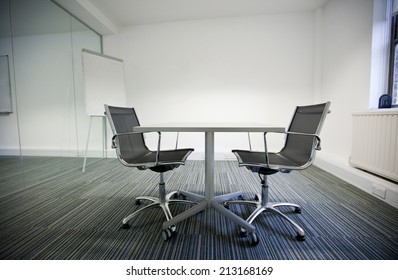 Side View Of Small Table And Two Chairs In Office