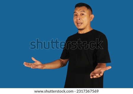 Side view of a smiling man with open arms posing