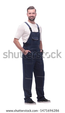 side view. smiling man in overalls looking forward to copy space
