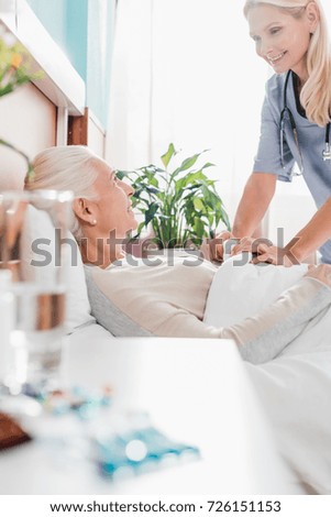 Similar – Female doctor giving medication to elderly patient