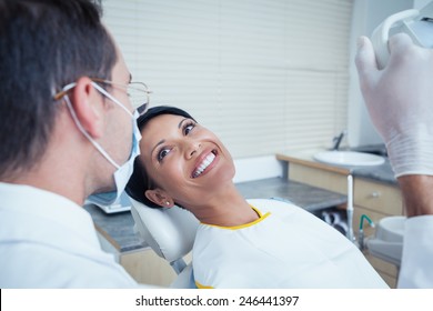 Side View Of Smiling Young Woman Waiting For A Dental Exam