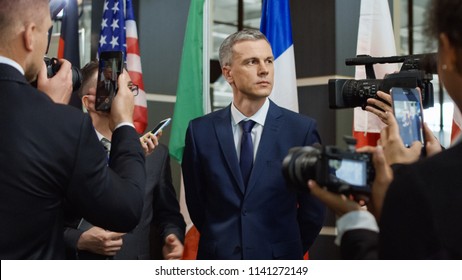 Side view of social media agents taking interview from male politician on international meeting - Shutterstock ID 1141272149