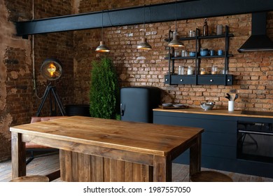 Side view of spacious industrial loft kitchen and living room with vintage decor and black cabinets - Shutterstock ID 1987557050