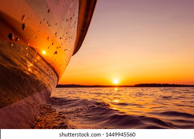 Side View Speeding Fishing Motor Boat With Drops Of Water. Blue Ocean Sea Water Wave Reflections At The Sunset. Motor Boat In The Blue Ocean. Ocean Yacht. Sunset At The Sailboat Deck
