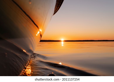 Side View Speeding Fishing Motor Boat With Drops Of Water. Blue Ocean Sea Water Wave Reflections At The Sunset. Motor Boat In The Blue Ocean. Ocean Yacht. Sunset At The Sailboat Deck