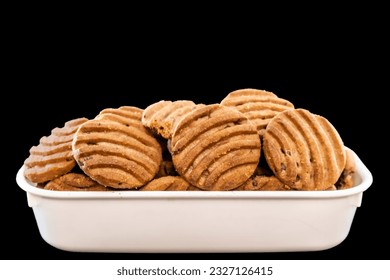 Side View Of A Stack Of Delicious Chocolate Chip Cookies In White Square Bowl on a Black Surface - Powered by Shutterstock