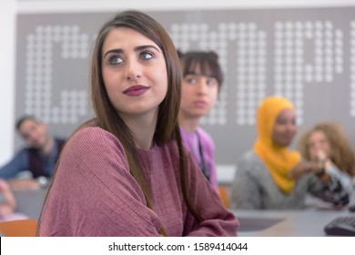 Side view of students using computer in lab. IT student looking and smiling into camera during class inside computer lab. - Shutterstock ID 1589414044