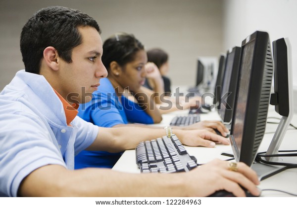 Side view of\
students using computer in\
lab