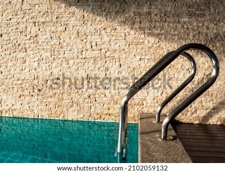 Side view of swiming pool handles near brick wall in hotel room. Close up pool handles