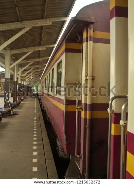 side view of thai vintage trains railway track,\
Perspective side view of old train bogies empty railway after\
maintenance for departure at platform station. No passenger.\
Thailand Travel Transport \
