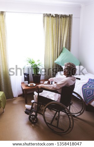 Similar – Senior woman in wheelchair alone in room