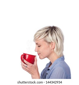 Side View At Thoughtful Young Blond Woman With Red Coffee Mug Against White Background