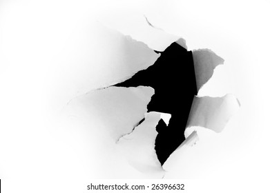 Side view of a torn jagged hole in paper
