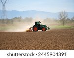 side view of tractor preparing the fields for cultivation