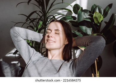 Side View Of Tranquil Smiling Pretty Caucasian Female Relaxing On Comfy Couch In Living Room. Peaceful Young Brunette Woman Sleeping, Reducing Stress, Enjoying Lazy Weekend Time On Sofa At Home