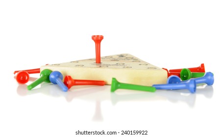 Side View Of A Triangular Pegboard Game.  One Piece Remains On The Board With The Others Scattered Nearby.  Shallow DOF With Focus On Winning Peg.  On A White Background.