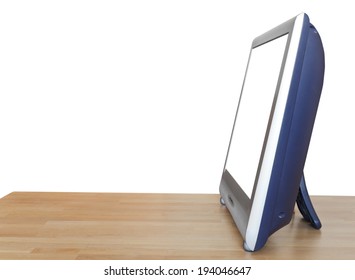 side view of TV set display with cutout screen on wood table isolated on white background