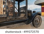 Side view of a vintage 1926 truck with a wooden bed shot at sunrise