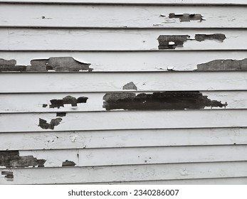 A side view of a wall with paint missing in spots.