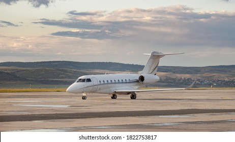 Side view of white business jet with turbofan engines at the airport. Modern technology in fast transportation, business travel and tourism, aviation concept.