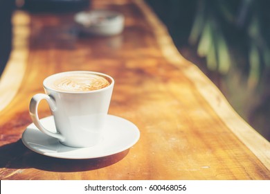 Side View A White Cup Coffee On Wooden Table,copy Space.