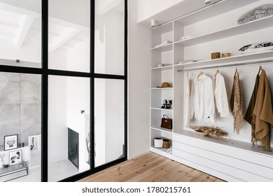 Side View Of White Wardrobe Closet In Dressing Room With Fashionable Woman Clothes, Shoes And Accessories